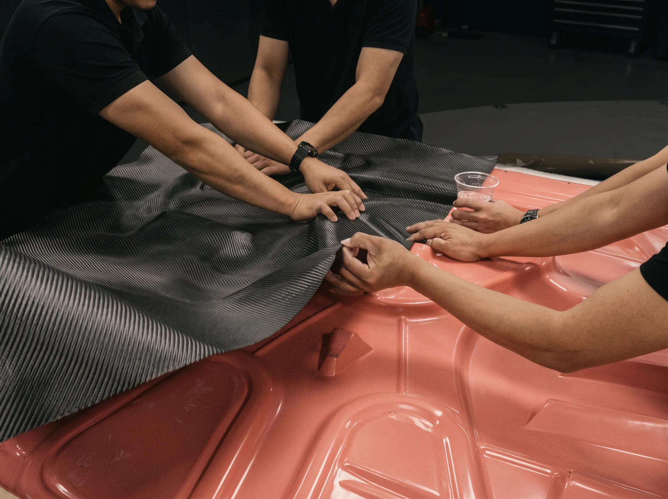 Hand-laying carbon fibre cloth into a mould at the Kynetik Koncepts workshop, Dubai