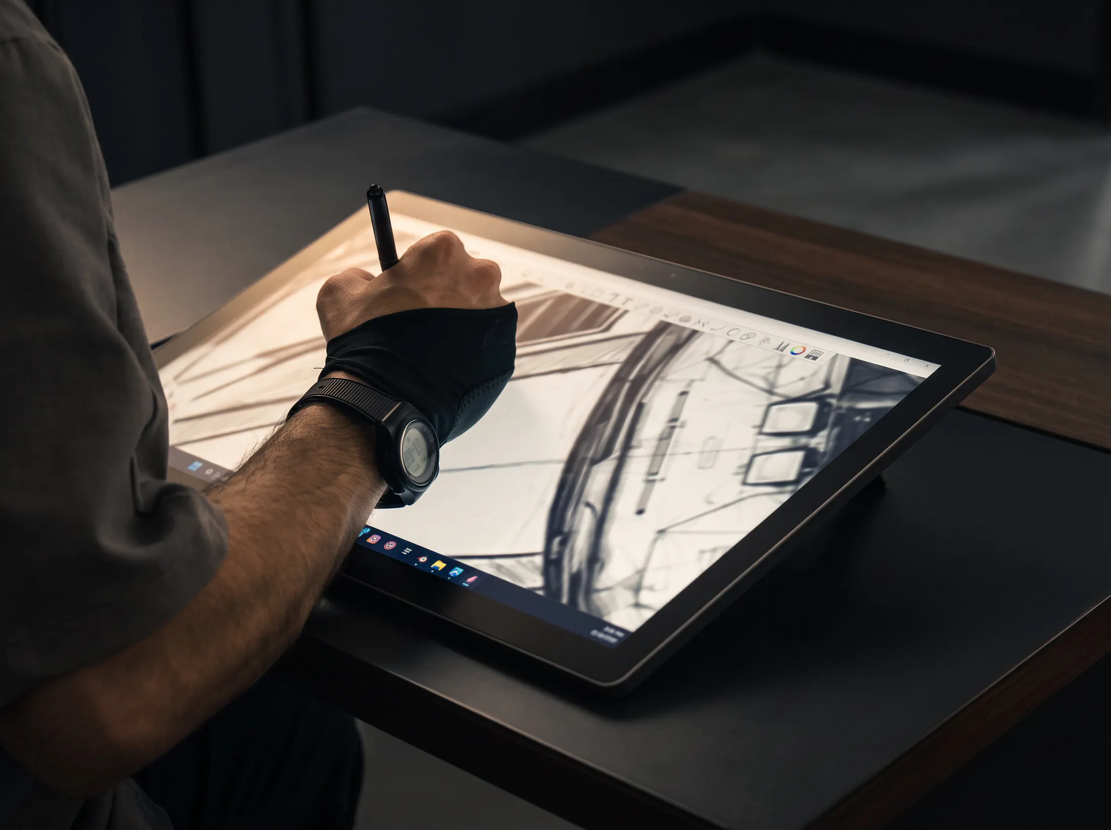 Kynetik Koncepts designer sketching a car on a drawing tablet
