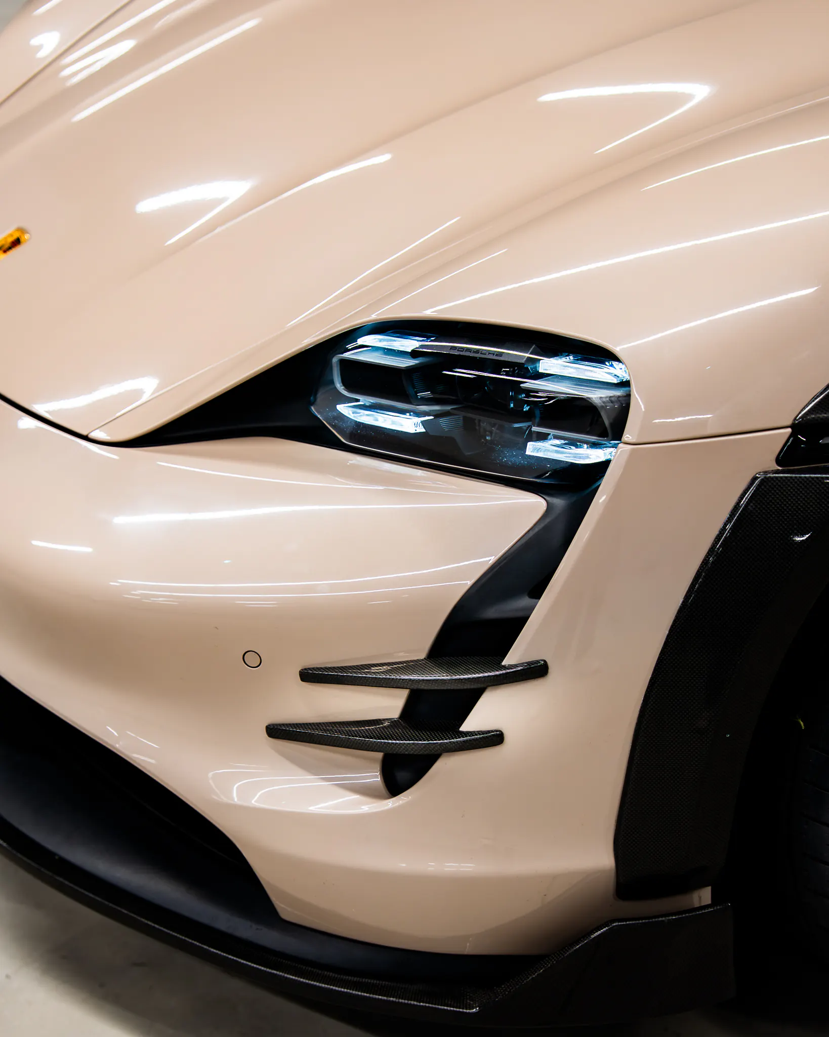 Fitment by Kynetik Koncepts — carbon fibre intake blades fitted to a Porsche Taycan front bumper