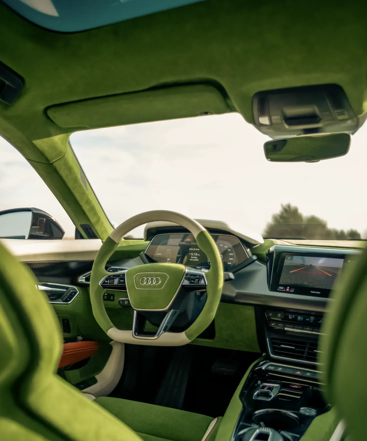 Interior customisation by Kynetik Koncepts — Audi RS e-tron GT cabin retrimmed in green suede with a cream and green steering wheel