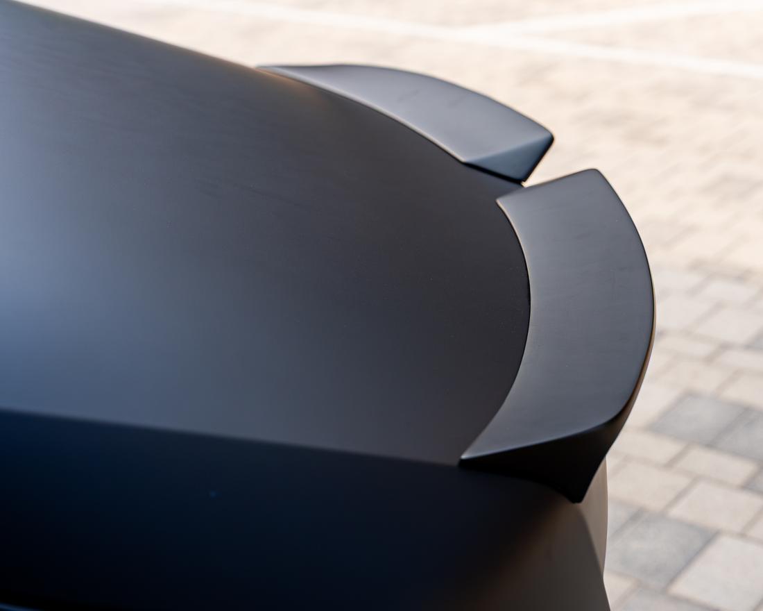 Matte carbon fibre coachwork detail by Kynetik Koncepts, raking light