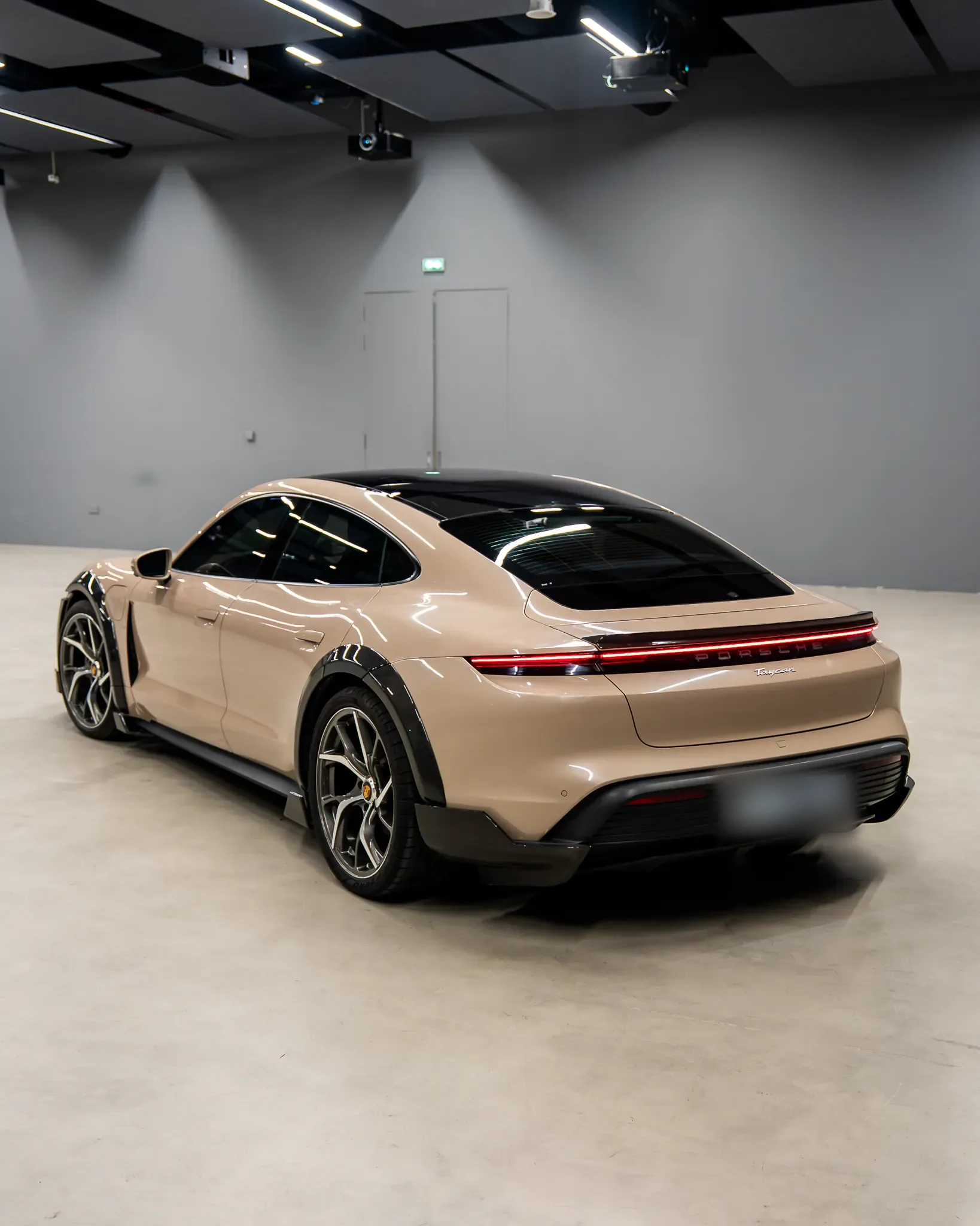 Porsche Taycan by Kynetik Koncepts — rear three-quarter, carbon diffuser